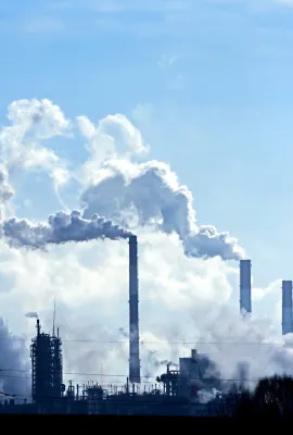 Air pollution from smoke coming out of factory chimneys